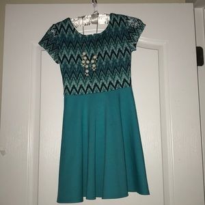 New,teal dress with a beautiful white necklace.